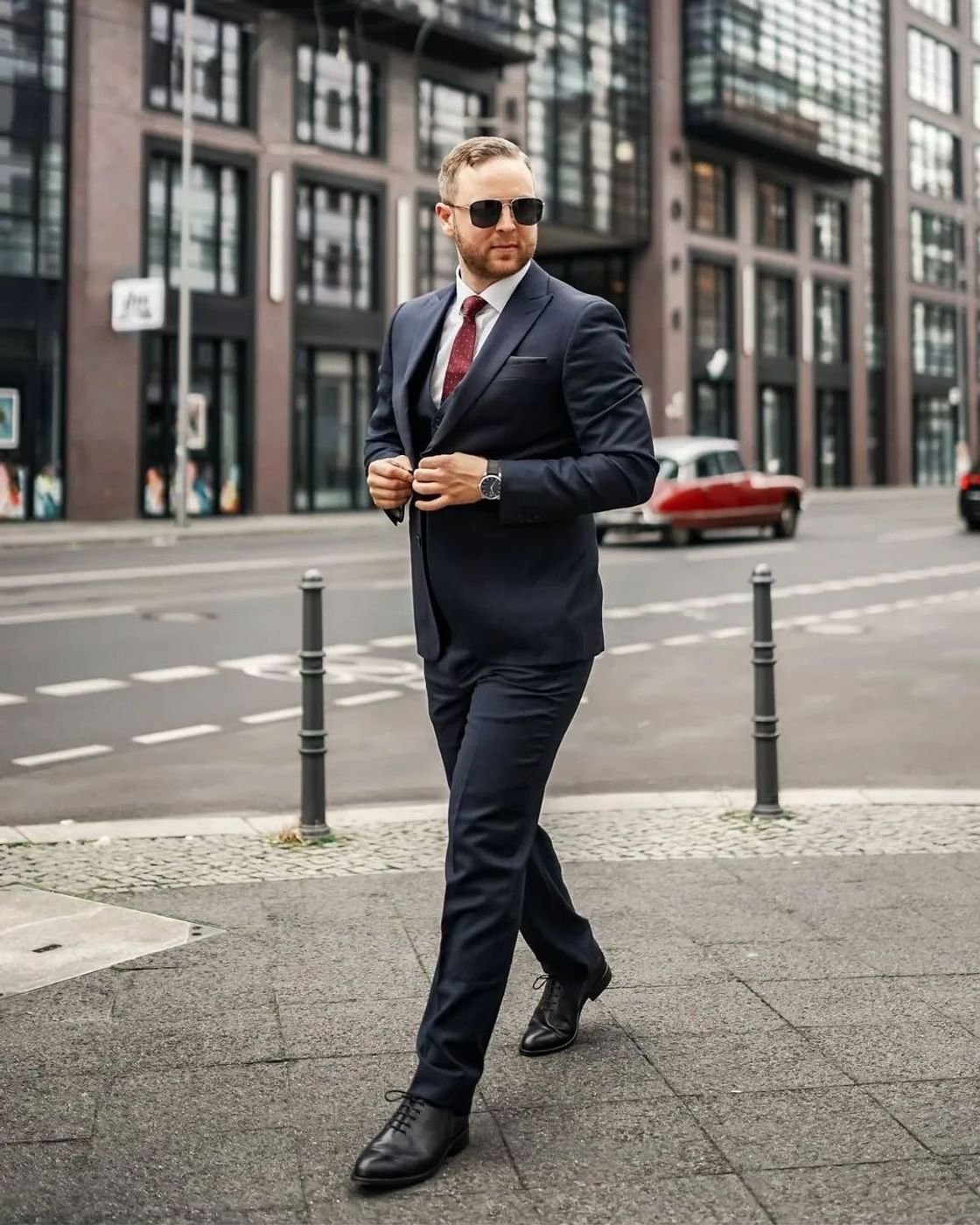 Man walking in stylish navy suit