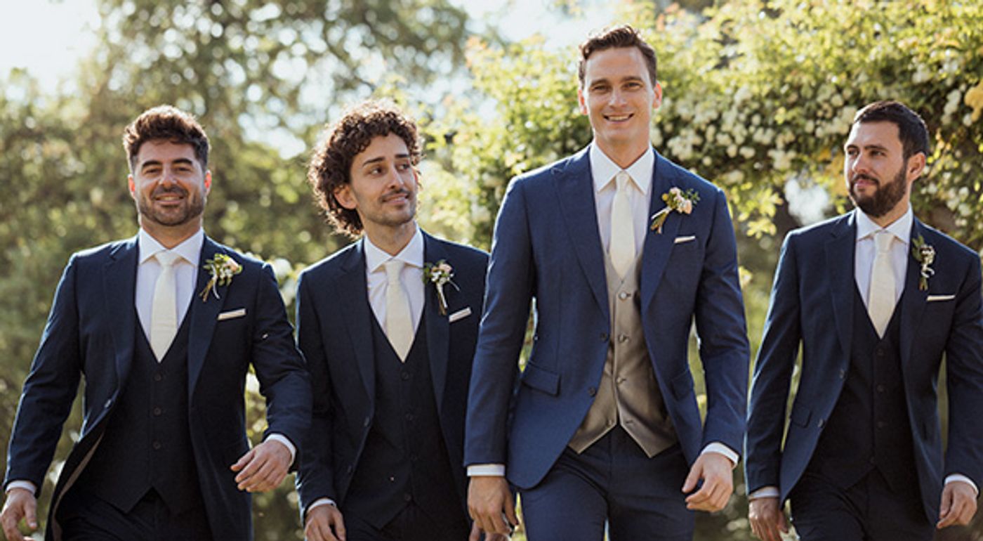 groom and groomsmen dressed in navy suits